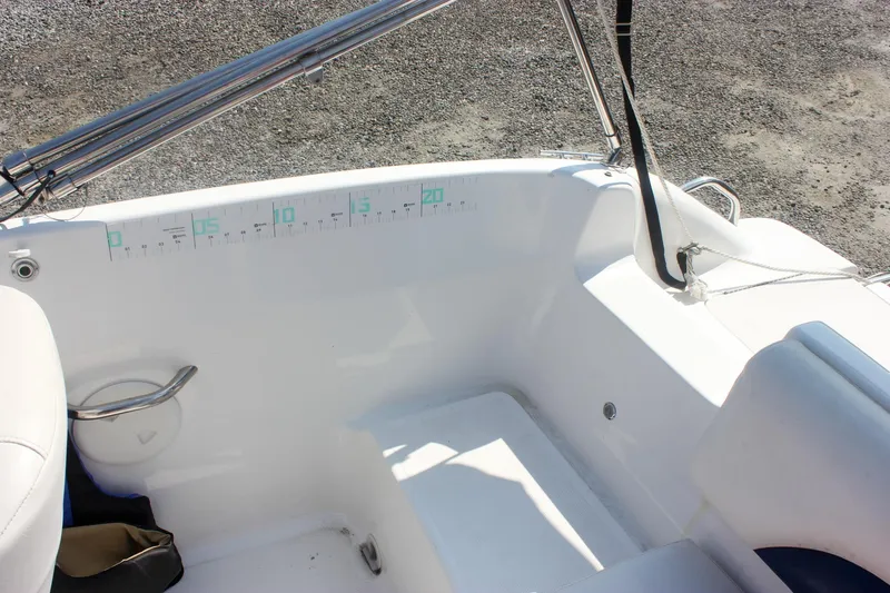 Slide: The Image of 2013 Hurricane SunDeck Sport 188 OB boat interior with seating and measurement markings. - 8