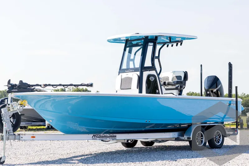 The Image of 2026 Tidewater 2410 Bay Max boat on trailer, vibrant blue hull, outdoor setting. - 1