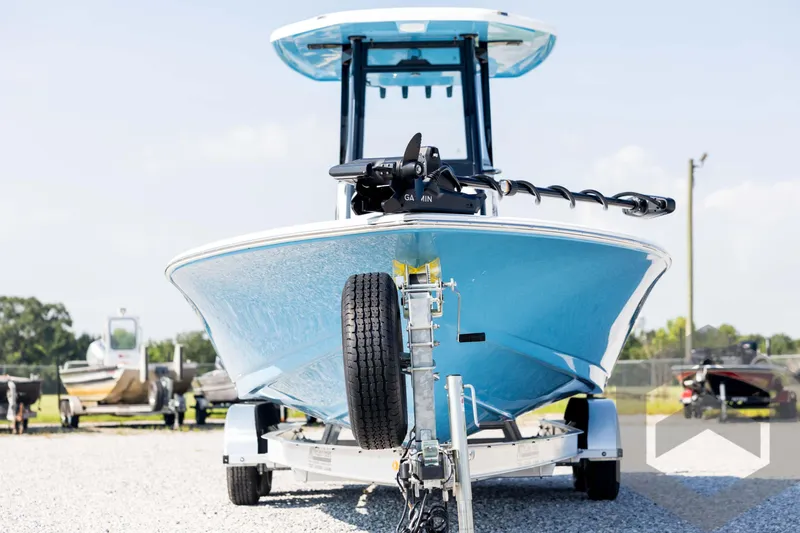 Slide: The Image of 2026 Tidewater 2410 Bay Max boat on trailer, front view, blue hull. - 2
