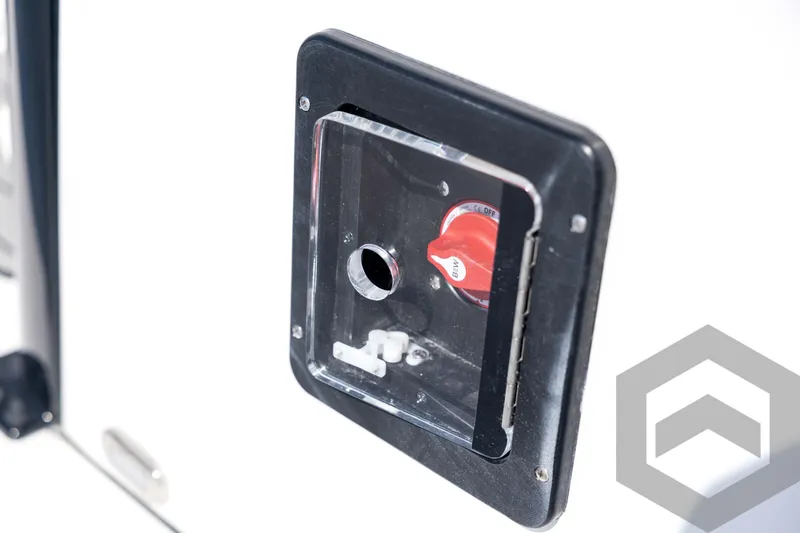 Slide: The Image of Close-up of 2026 Tidewater 2410 Bay Max boat control panel with red switch. - 27