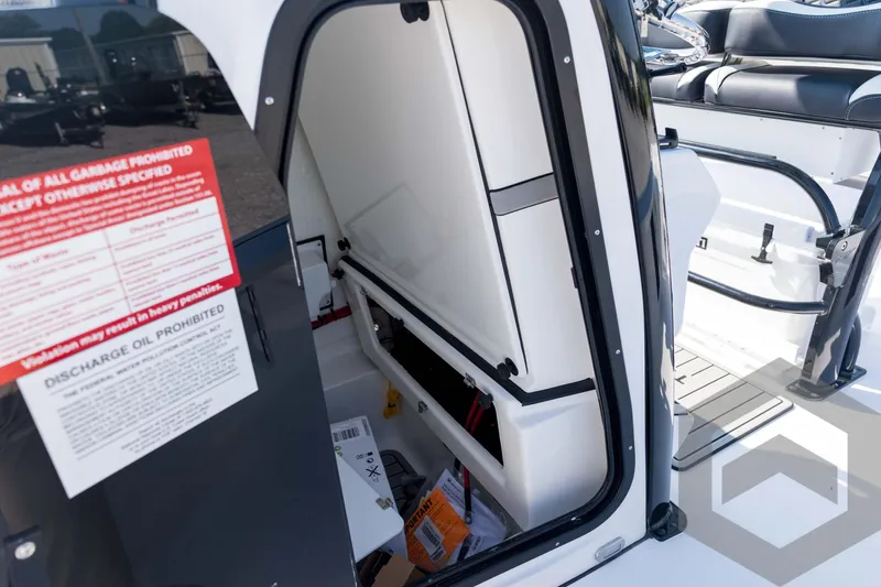 Slide: The Image of 2026 Tidewater 2410 Bay Max boat interior storage compartment with safety instructions. - 33