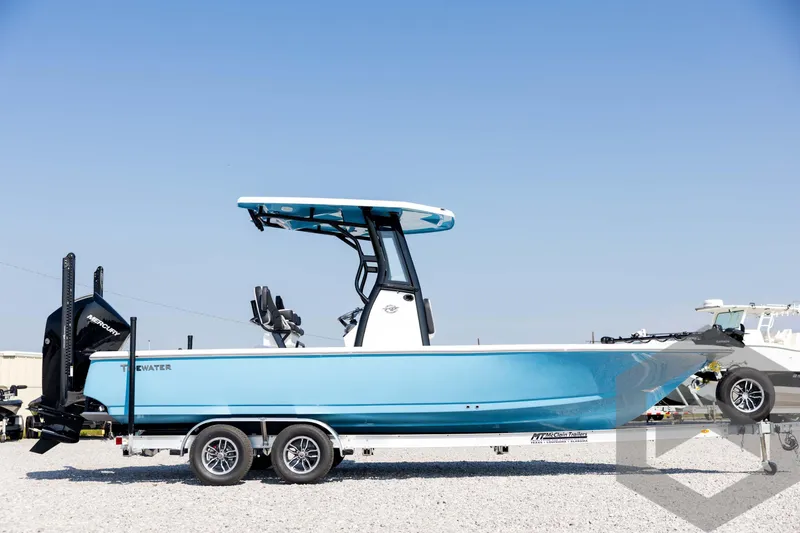 Slide: The Image of 2026 Tidewater 2410 Bay Max boat on trailer, blue hull, clear sky background. - 4