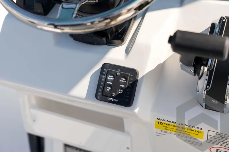 Slide: The Image of Control panel of 2026 Tidewater 2410 Bay Max boat, featuring steering wheel and capacity label. - 41