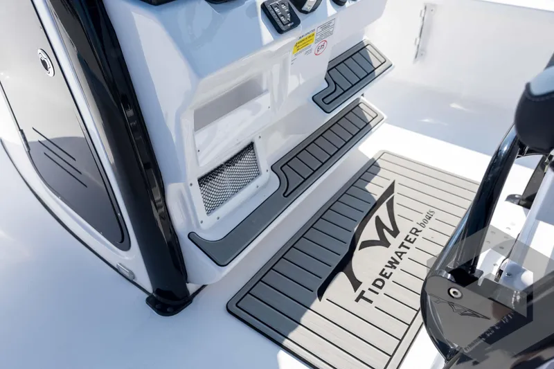 Slide: The Image of 2026 Tidewater 2410 Bay Max boat interior with branded mat and step details. - 43