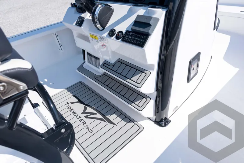 Slide: The Image of 2026 Tidewater 2410 Bay Max boat interior with console and branded flooring. - 44