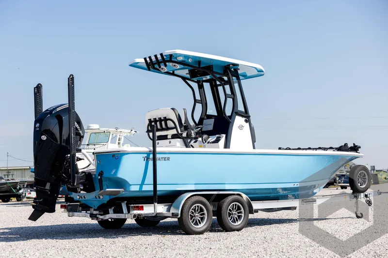Slide: The Image of 2026 Tidewater 2410 Bay Max boat on trailer, blue hull, dual engines, sunny day. - 5