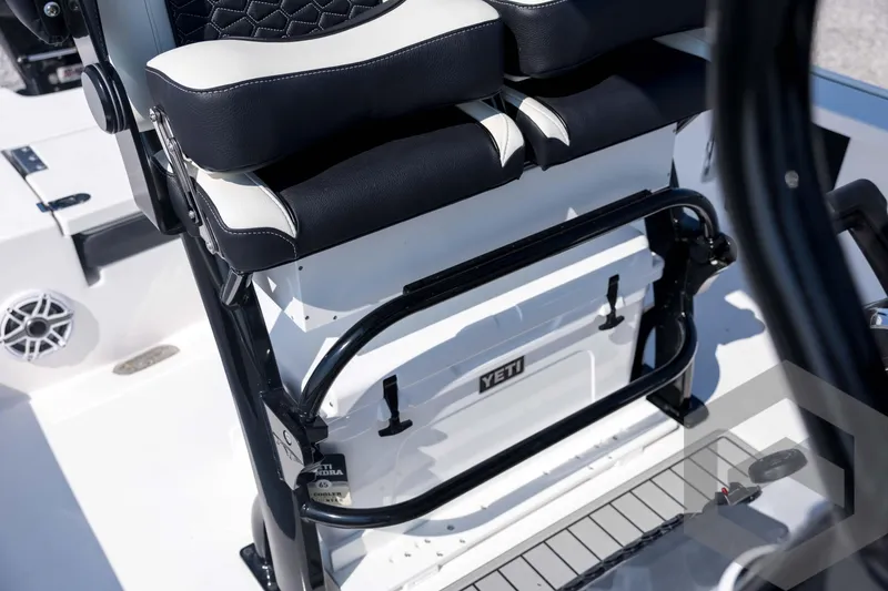 Slide: The Image of 2026 Tidewater 2410 Bay Max boat interior with Yeti cooler and cushioned seating. - 50