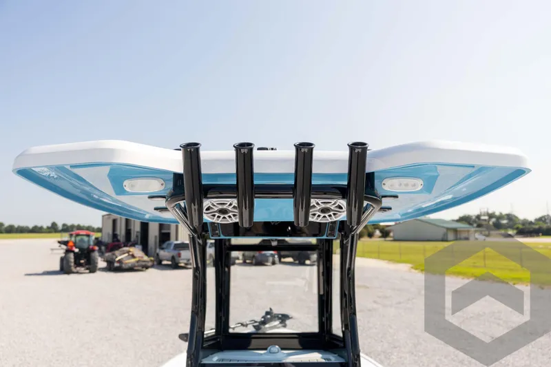 Slide: The Image of 2026 Tidewater 2410 Bay Max boat with T-top and rod holders, outdoor setting. - 51