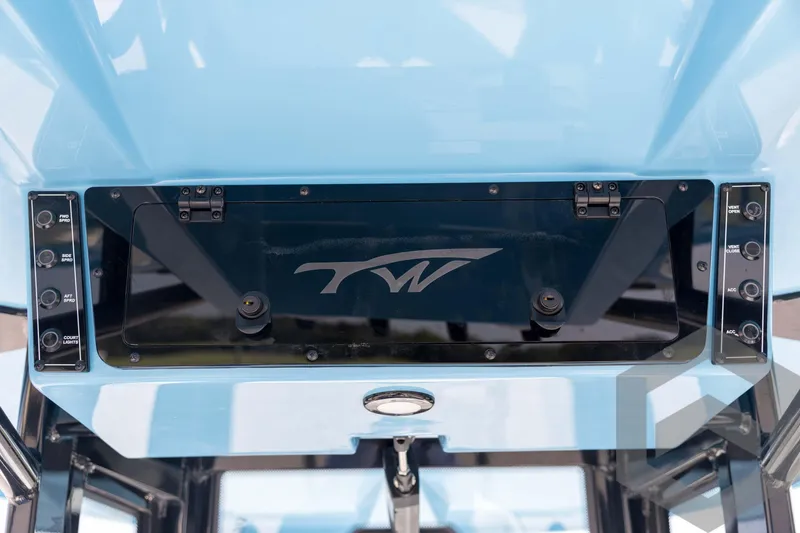 Slide: The Image of 2026 Tidewater 2410 Bay Max boat console with control panel and logo. - 53