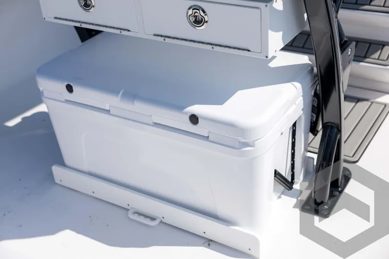 Slide: The Image of 2026 Tidewater 2410 Bay Max boat interior with white storage compartment and seating. - 60