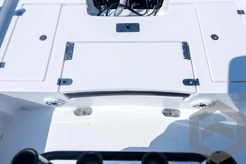 Slide: The Image of 2026 Tidewater 2410 Bay Max boat deck with storage compartments and control panel. - 63