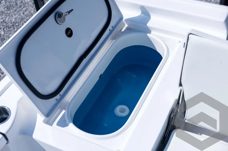 Slide: The Image of Livewell compartment on 2026 Tidewater 2410 Bay Max boat, featuring a blue interior. - 66