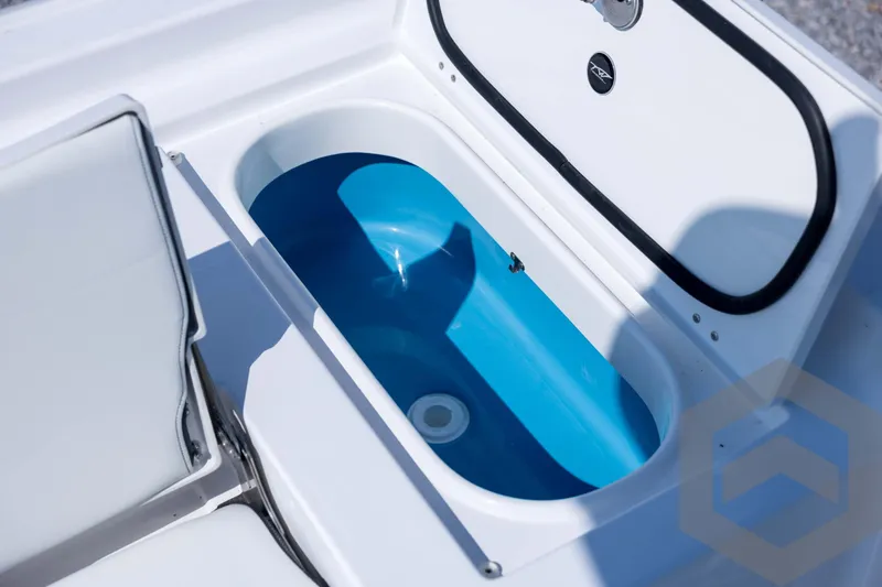 Slide: The Image of 2026 Tidewater 2410 Bay Max boat livewell with open lid, showcasing interior design. - 67