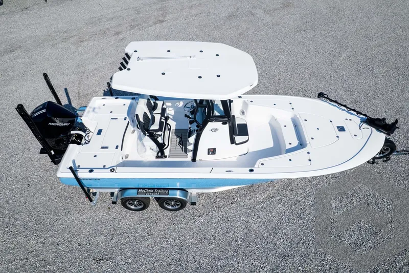 Slide: The Image of 2026 Tidewater 2410 Bay Max boat on trailer, aerial view, white and blue design. - 82