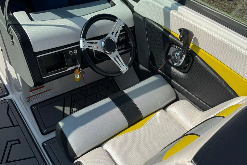 Slide: The Image of 2017 Four Winns TS242 boat interior with steering wheel and control panel. - 10