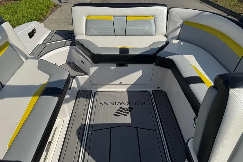 Slide: The Image of 2017 Four Winns TS242 boat interior with stylish seating and logo on deck. - 11
