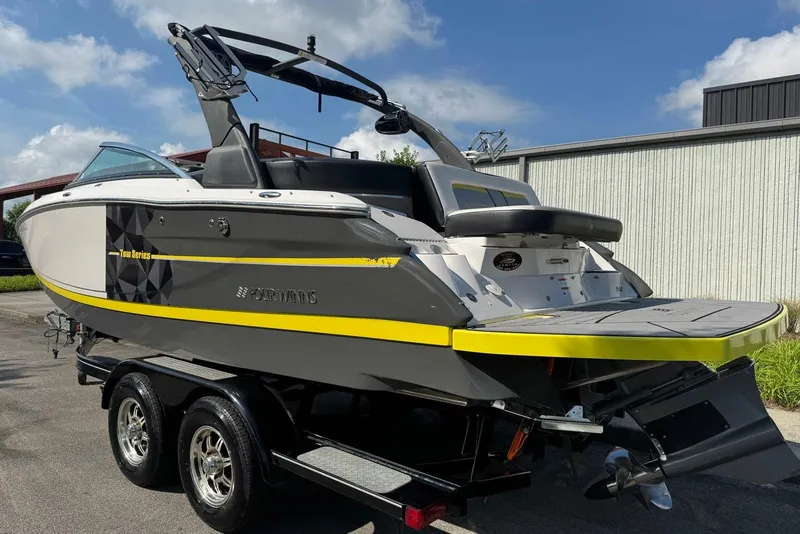 Slide: The Image of 2017 Four Winns TS242 boat on trailer, featuring sleek design and vibrant yellow accents. - 2