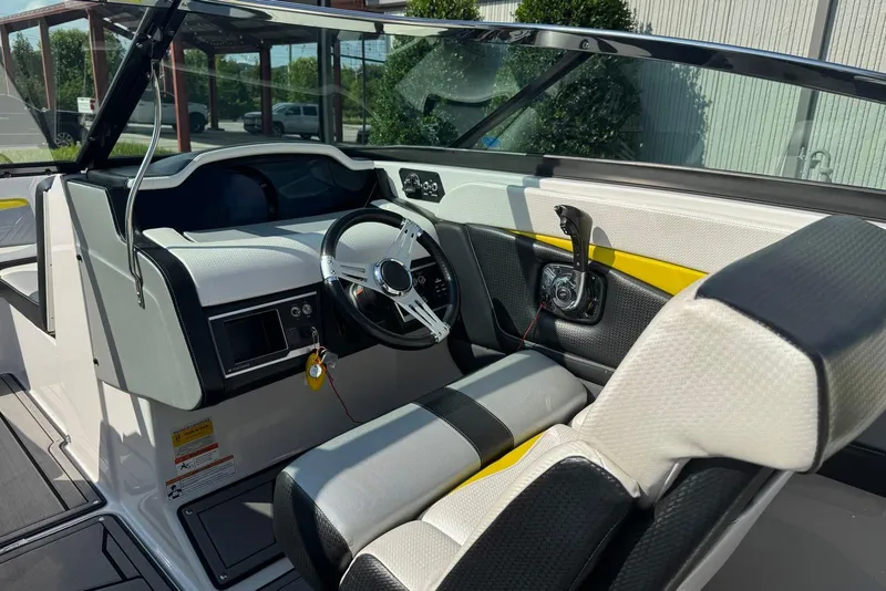 Slide: The Image of 2017 Four Winns TS242 boat interior with steering wheel and dashboard controls. - 6