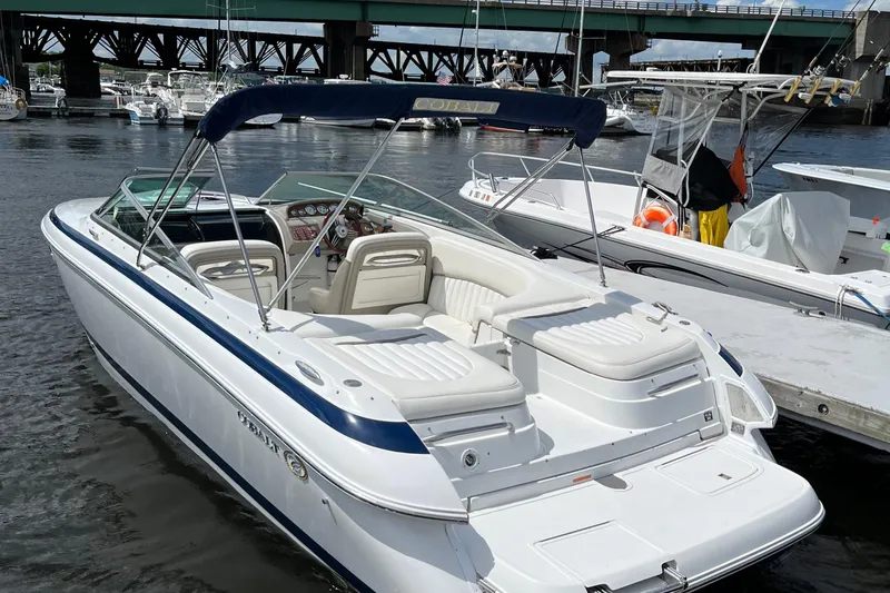 The Image of A 2003 Cobalt 263 boat docked in a marina, featuring sleek white and blue design. - 0
