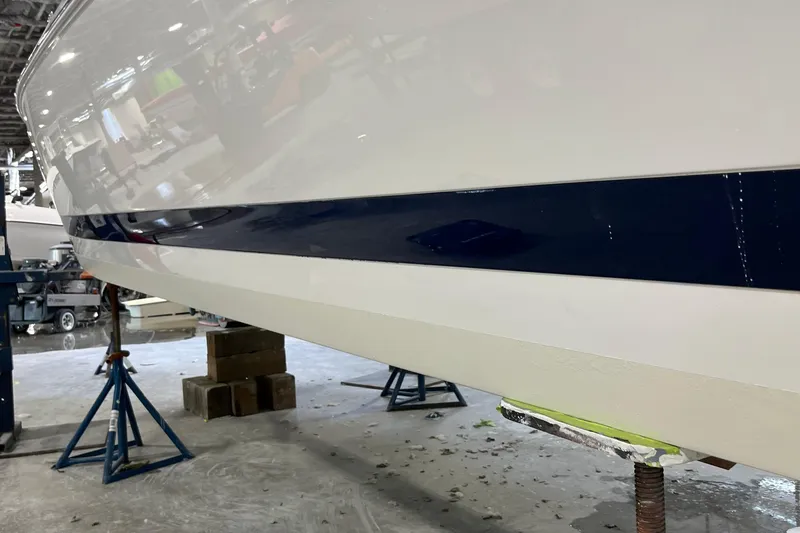 Slide: The Image of 2003 Coblat 263 boat hull in a workshop, supported by stands. - 10