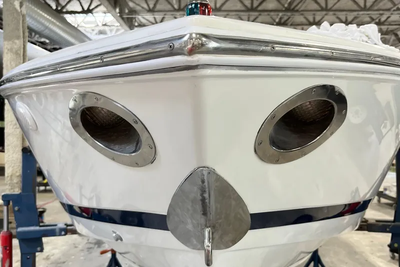 Slide: The Image of Front view of a 2003 Cobalt 263 boat in a warehouse setting. - 11