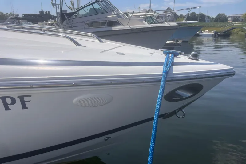 Slide: The Image of 2003 Cobalt 263 boat docked with blue rope, marina background. - 15