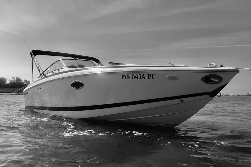 Slide: The Image of 2003 Cobalt 263 boat on water, black and white photo, side view. - 17