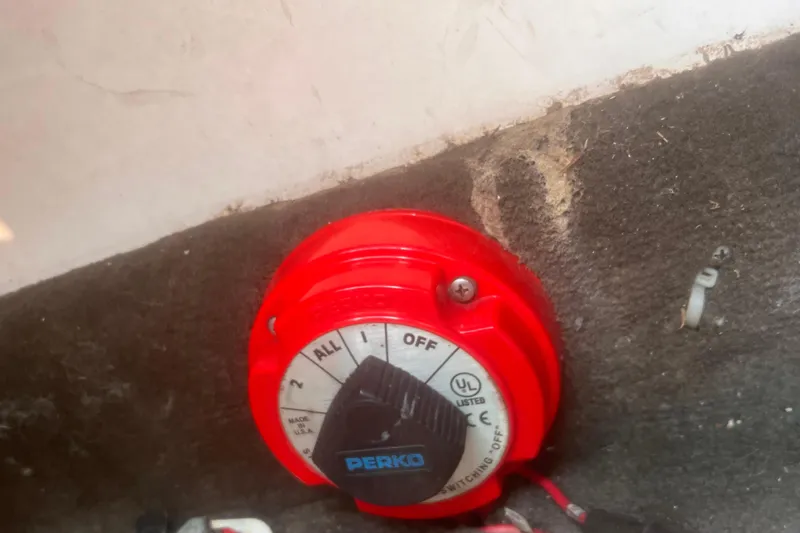 Slide: The Image of Red Perko battery switch on carpeted surface, Cobalt 263, 2003 model. - 20