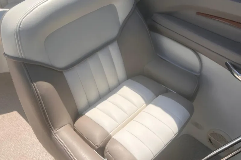 Slide: The Image of 2003 Cobalt 263 boat interior seat with beige and white upholstery. - 23