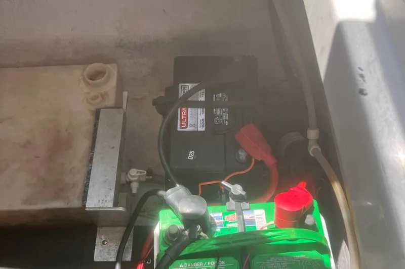 Slide: The Image of Battery compartment of a 2003 Coblat 263 with visible wiring and connections. - 25