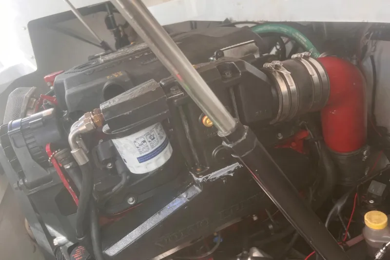 Slide: The Image of Engine compartment of a 2003 Cobalt 263 boat, featuring visible components and hoses. - 26