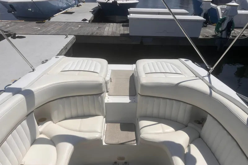 Slide: The Image of Interior of a 2003 Coblat 263 boat with white leather seating at a dock. - 3