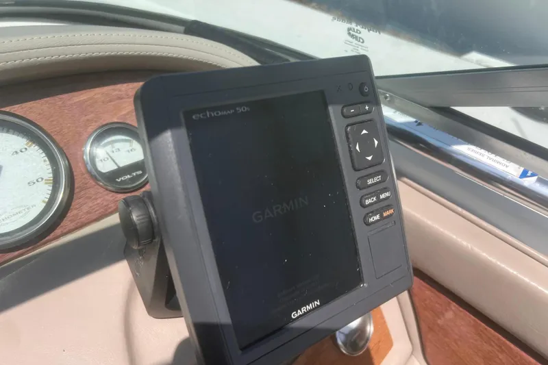 Slide: The Image of Garmin GPS device on 2003 Cobalt 263 boat dashboard with gauges. - 30