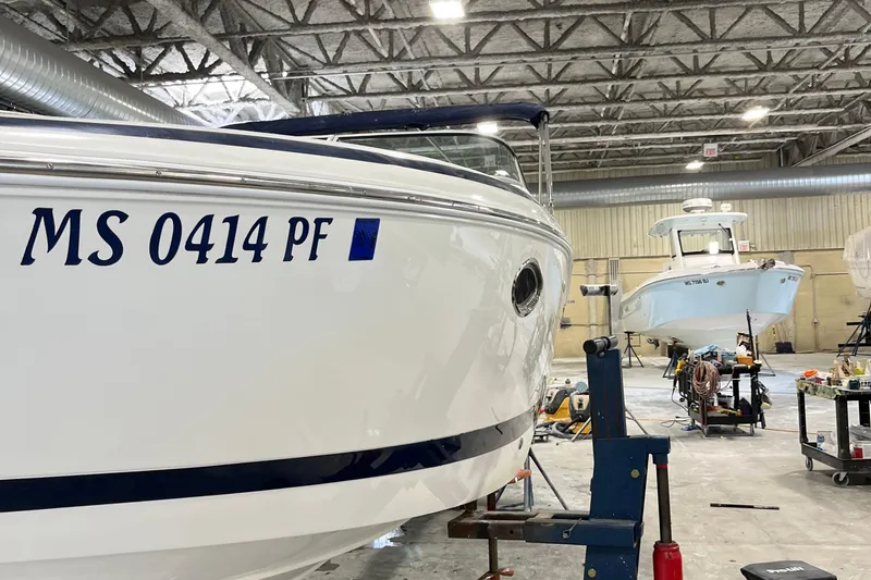 Slide: The Image of Boat repair shop with 2003 Cobalt 263 and another boat in the background. - 31