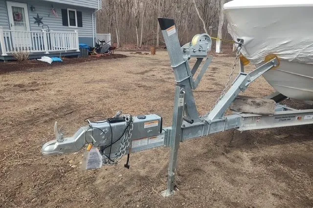 Slide: The Image of Trailer hitch of a 2003 Cobalt 263 boat parked in a yard. - 34