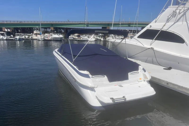 Slide: The Image of 2003 Cobalt 263 boat docked in marina, covered with navy blue canopy. - 4