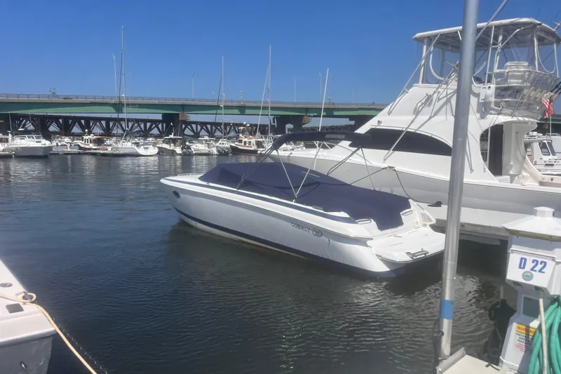 Slide: The Image of White Cobalt 263 boat docked in marina, 2003 model, under clear blue sky. - 5