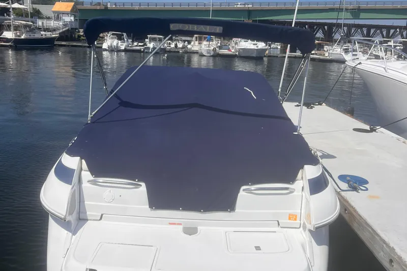 Slide: The Image of 2003 Cobalt 263 boat docked at marina with blue cover. - 6