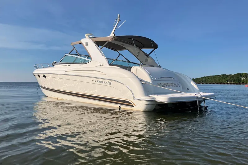 The Image of 2001 Formula 400ss boat on calm water under clear blue sky. - 0