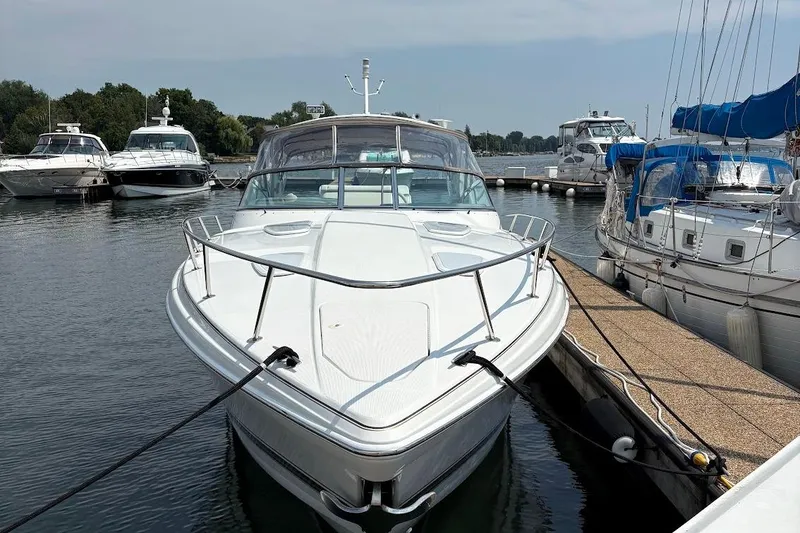 Slide: The Image of 2001 Formula 400ss boat interior with seating and table, docked by the water. - 6
