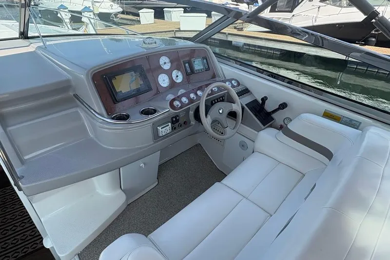 Slide: The Image of 2001 Formula 400ss boat interior with dashboard, steering wheel, and white seating. - 8