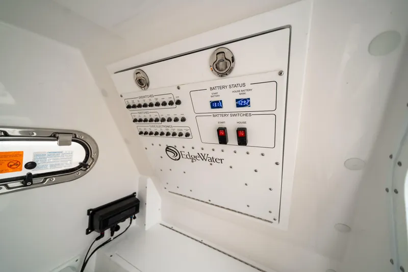 Slide: The Image of Edgewater 250 CC 2026 boat control panel with battery status indicators and switches. - 11