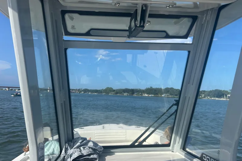 Slide: The Image of Interior view from a 2026 Edgewater 250 CC boat, overlooking a serene waterway. - 5