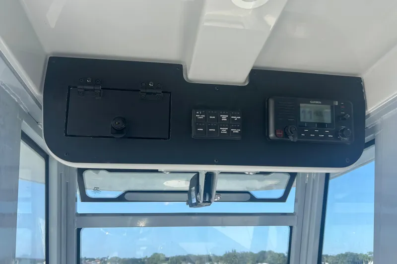 Slide: The Image of 2026 Edgewater 250 CC boat dashboard with Garmin device and control panel. - 6