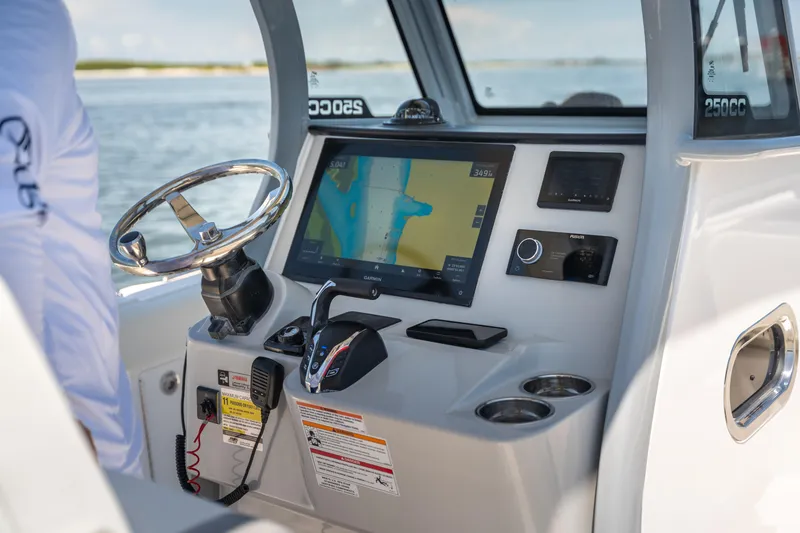 Slide: The Image of Edgewater 250 CC 2026 boat dashboard with navigation system and controls. - 9