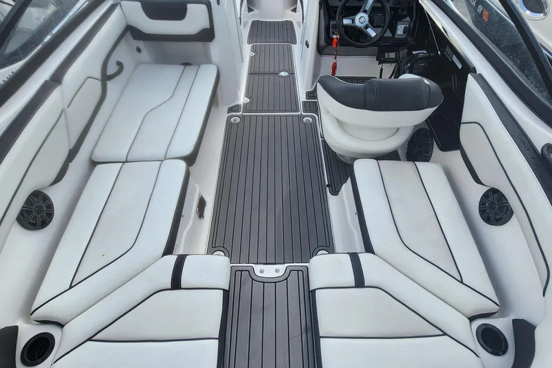 Slide: The Image of 2018 Yamaha Boats SX210 interior with white seating and sleek black accents. - 5