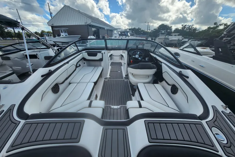 Slide: The Image of 2018 Yamaha Boats SX210 interior with sleek seating and modern dashboard. - 6