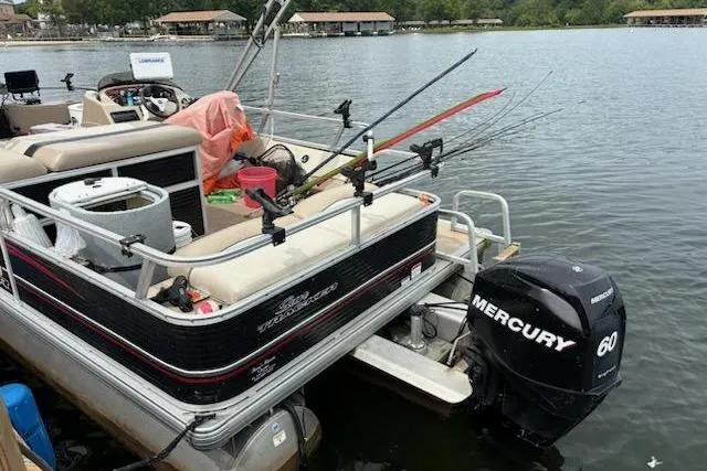 Slide: The Image of 2013 Sun Tracker Fishing Barge 22 with Mercury 60 engine, equipped for fishing on a lake. - 4