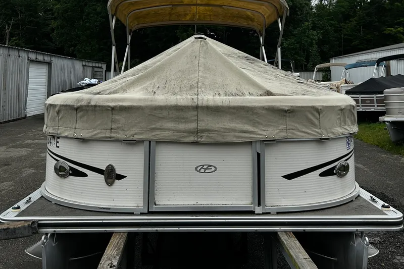 Slide: The Image of 2009 Harris CRUSIER 220 pontoon boat with cover, parked outdoors. - 4