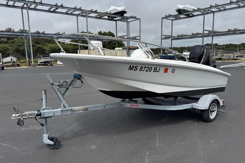 The Image of 2018 Boston Whaler 130 Super Sport boat on trailer in parking lot. - 1